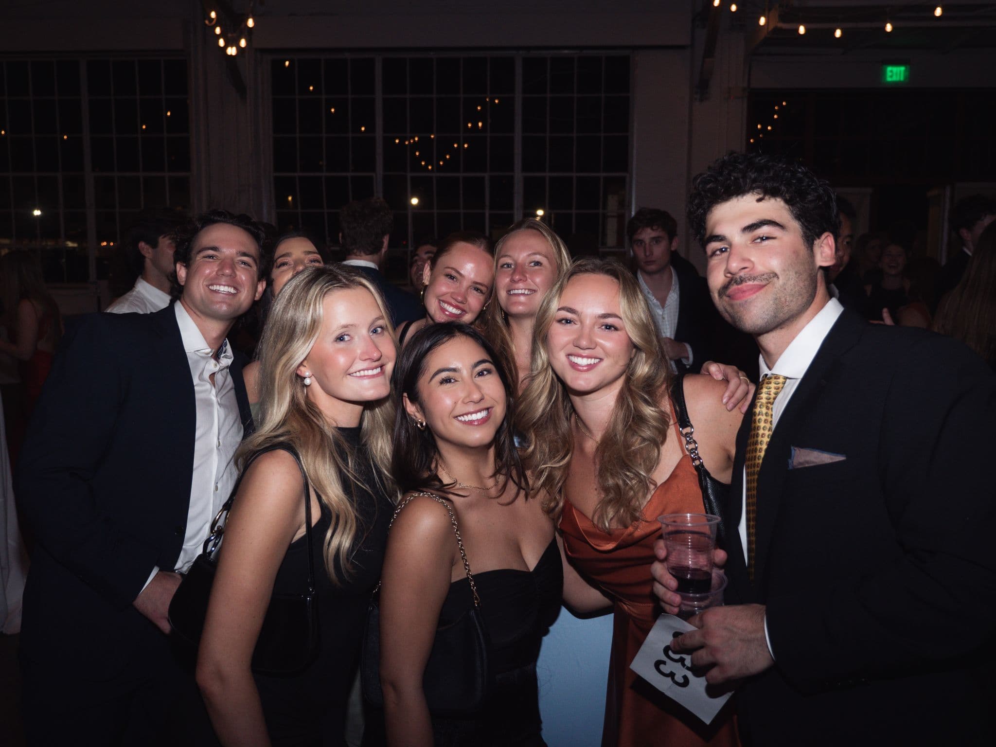 Friends dressed up and smiling at the Harvest Moon Gala